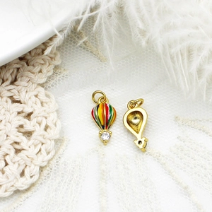 Golden hot air balloon pendant with colorful enamel details and sparkling zircon accent