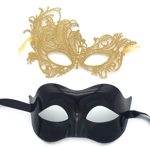Detail of gold lace and black glossy half-face masquerade masks with ribbons