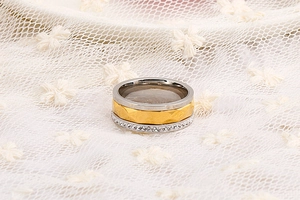 Macro shot of three-in-one stacked rings with gold, silver layers and white crystal accents