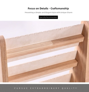 Macro detail of multi-tier wooden necklace display stand with soft beige notched velvet slots