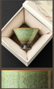 Close-up of green star ceramic tea cup showing unique kiln glaze detail in a gift box