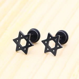 Macro shot of black stainless steel hexagram stud earrings on a natural wood background