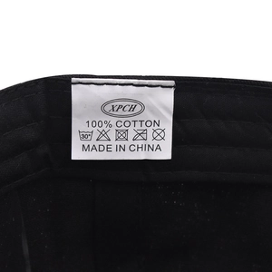 Close-up of 100% cotton inner lining and wash label on black baseball cap
