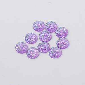 Macro view of 10 purple 12mm round faux druzy resin cabochons with iridescent texture