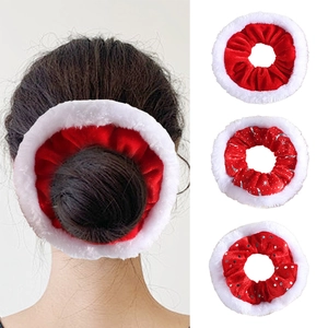 Detail of plush Christmas scrunchies in red velvet with silver stars and dots patterns