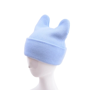Detailed close-up of light blue knitted beanie with cute animal ears and ribbed fold-over cuff