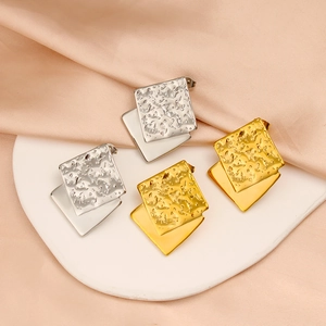 Modern gold and silver layered square stud earrings with textured finish and smooth base