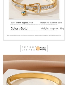 Macro detail of gold titanium steel belt buckle bracelet with zircon and blue evil eye charm
