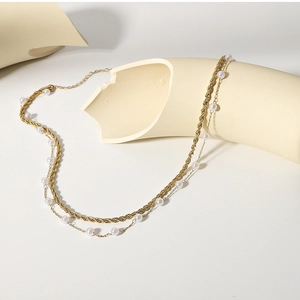 Close-up of dual-layer gold-plated 18K stainless steel chain with small white pearls