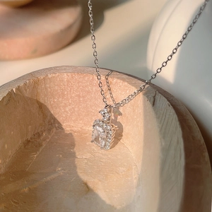 Macro detail of S925 silver necklace with rectangular zircon pendant in sunlight