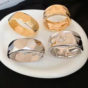 Irregular geometric metal bangles in polished gold and silver finish set of four