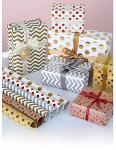 Detail of patterned gift wrapping paper with metallic finish and decorative ribbons