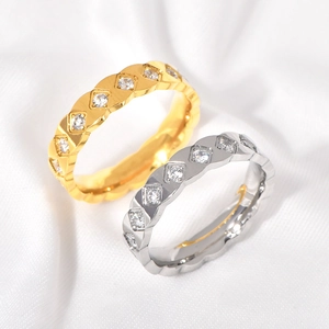 Elegant gold and silver diamond rhombus rings displayed on soft white silk fabric