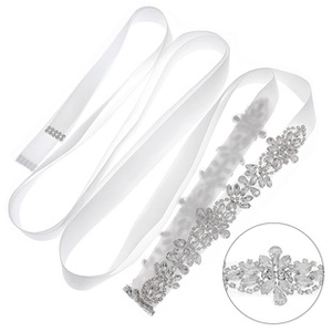 Close-up of luxury bridal belt featuring intricate crystal rhinestones on white ribbon