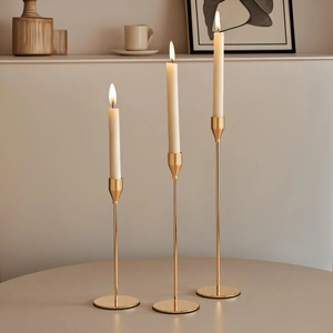 Modern set of three gold slender metal candle holders for elegant wedding table decor
