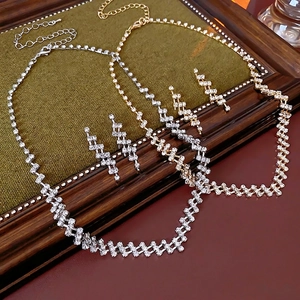 Luxury diamond-encrusted zigzag jewelry set including gold and silver necklaces and earrings