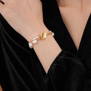 Detailed view of double-layer freshwater pearl bracelet with gold OT toggle clasp on wrist