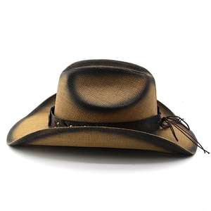 Detail of western straw cowboy hat with burnished brim and studded leather band