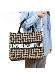 Detail of jute tote bag with houndstooth pattern and LOVE printed stripe handle