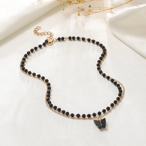 Gothic double layer butterfly pendant necklace with black beads and gold-tone chain on satin