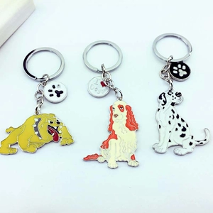 Three cute metal cartoon dog keychains with I Heart Dogs tag on white background