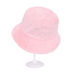 Close-up of pink faux fur bucket hat showing soft plush texture on white stand
