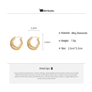 Detail view of double-layered gold earrings with zircons measuring 2.2cm by 2.2cm