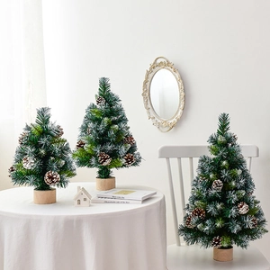 Set of three mini snow-frosted Christmas trees with natural pine cones on wood bases