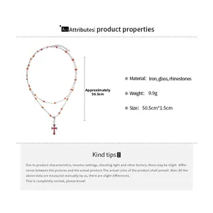 Detail showing red rhinestone cross pendant and orange beads on silver double layer necklace