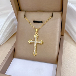 Close-up of gold-plated cross pendant necklace with sparkling pavé cubic zirconia