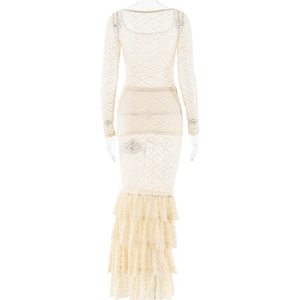 Detail view of the tiered beige lace skirt with long sleeves on a model from the back