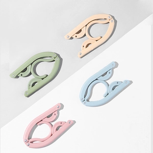 Portable folding clothes hangers in four pastel colors for travel and organization