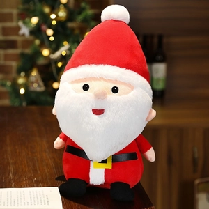 Close-up of a plush Santa Claus doll with red hat and fluffy beard in a cozy holiday setting