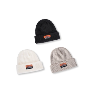 Classic knitted beanies in black, off-white, and grey with a stylish woven patch label