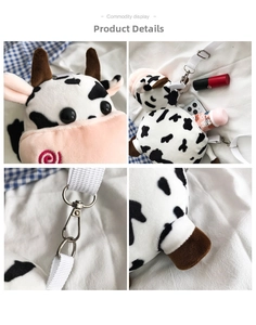 Detail view of cow plush crossbody bag showing silver metal hooks and interior storage space