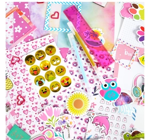 Close-up of DIY journal set with stickers, sunflower patterns and heart paperclips