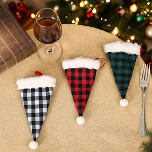 Plaid Christmas cutlery holder set with plush trim shown in a festive holiday dining scene