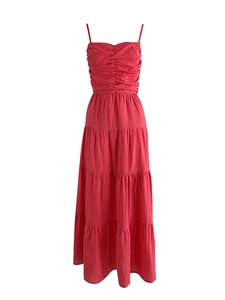 Detailed view of the red tiered maxi dress featuring ruched bodice and pleated texture