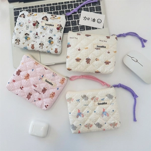 Detailed flat lay of four floral quilted cosmetic bags with soft cotton texture