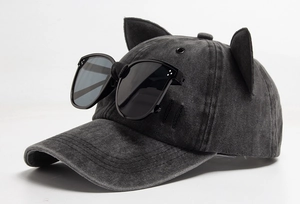 Macro detail of pilot-style pilot baseball cap with cat ears and decorative sunglasses