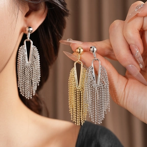 Detailed comparison of gold and silver tassel earrings with delicate metal chains