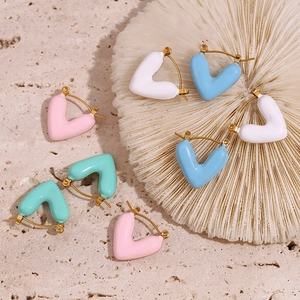 Detail of colorful 18K gold plated heart earrings in pink, blue, white, and mint enamel