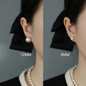 Elegant white pearl stud earrings in 8mm and 12mm sizes displayed on a model