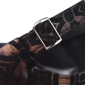Macro view of adjustable silver metal buckle on textured black and bronze plaid cap