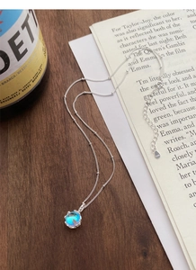 Detail of S925 sterling silver chain with aurora blue gemstone pendant and lobster clasp