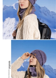 Close-up of purple knit beanie and neck warmer set against a scenic snowy mountain backdrop