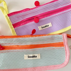 Detail of dual-layer mesh pencil case with colorful zippers and vibrant contrast design