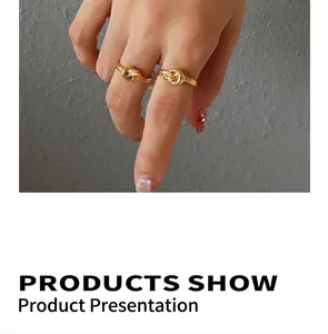 Close-up of dual chunky knotted 18k gold plated titanium steel rings on a model hand