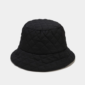 Close-up of black quilted bucket hat with classic diamond stitching and premium texture
