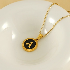 Gold titanium steel necklace with black round pendant featuring a golden letter A